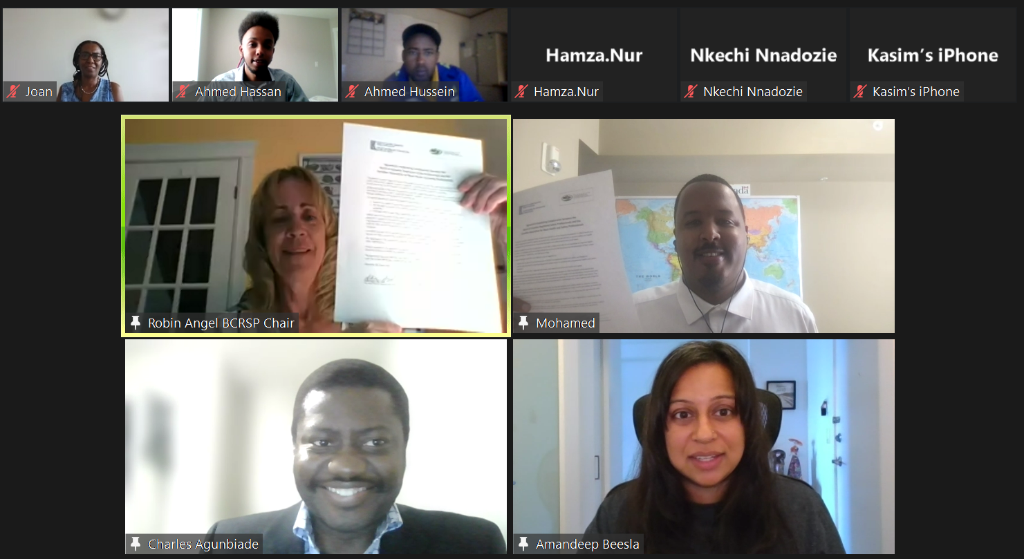 Zoom call screenshot that shows 6 small tiles and 4 large, with Robin Angel, Mohamed Hassan, Charles Agunbiade and Amandeep Beesla and the signing of an agreement between BCRSP and CABSHP