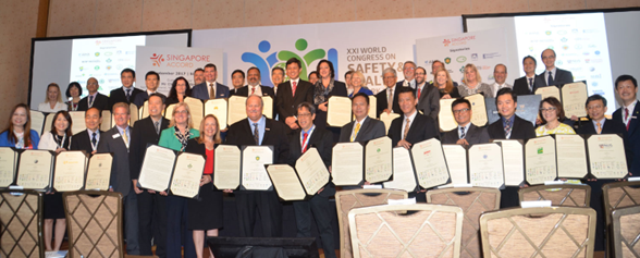 Photo of the people who represent the organisations that signed the Singapore Accord, standing in a group holding copies of the Accord.